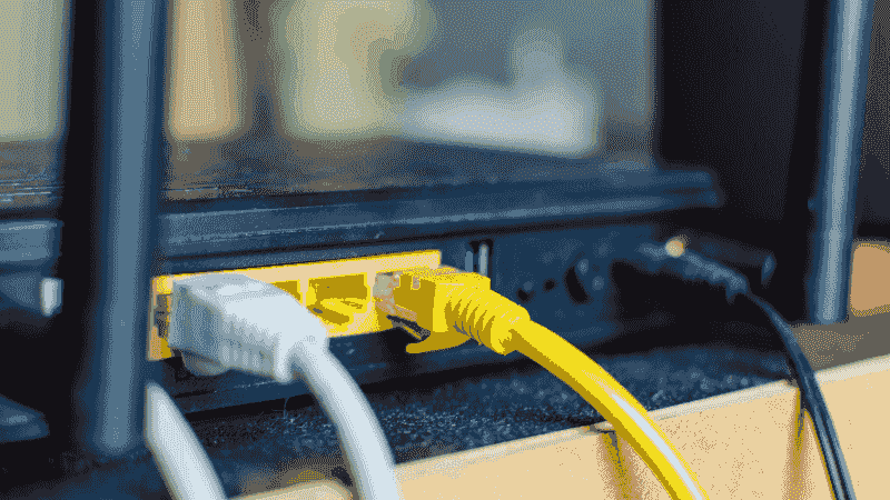 The back of a modem with two cords plugged.