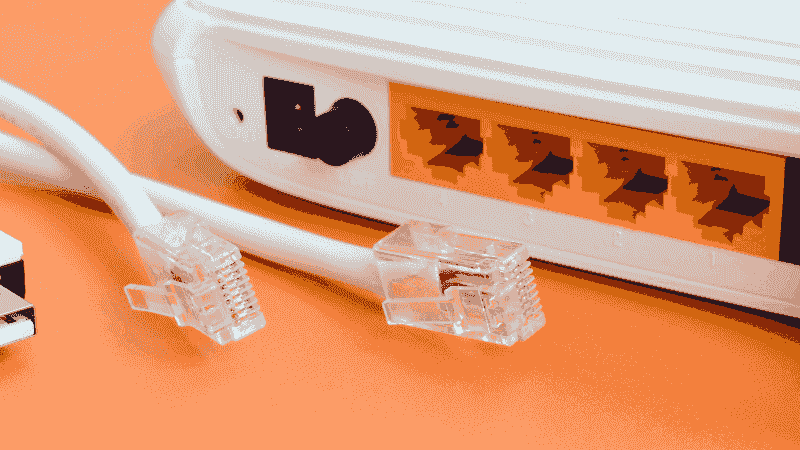 The back of an router showing ethernet cables.