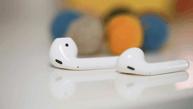 airpods on kitchen table with fruits in the back