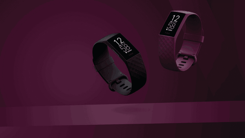 2 Fitbits, Black and purple with a purple background.