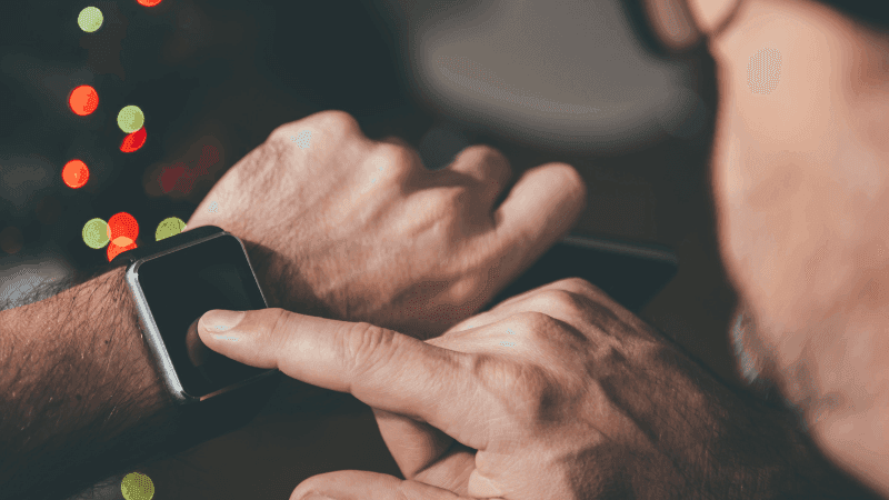 man checking his apple watch with finger on screen