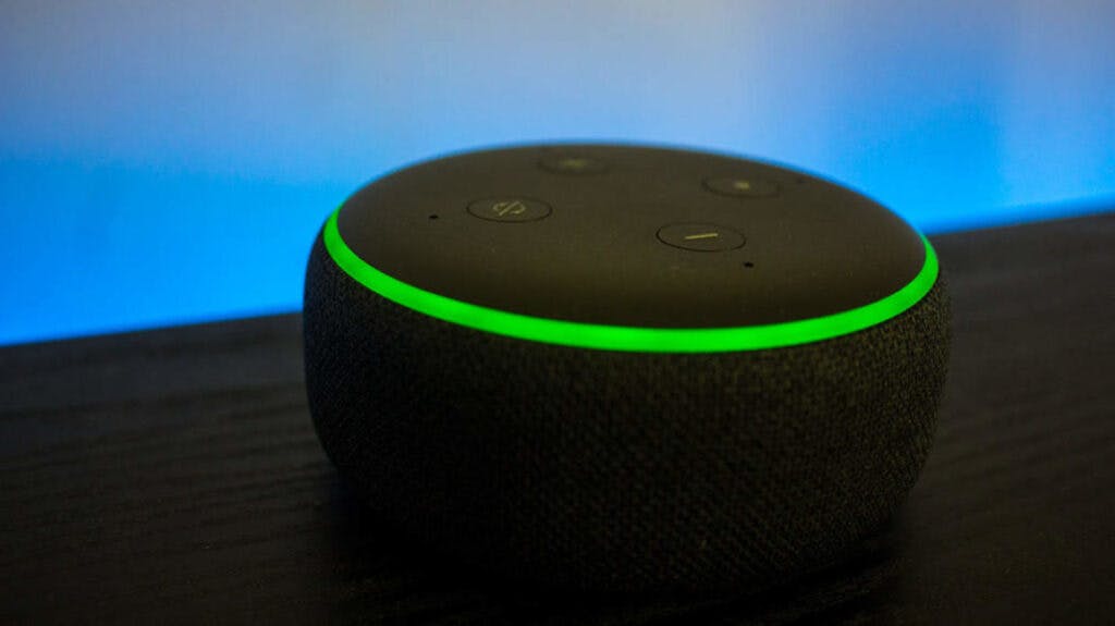 Close up on Echo Dot with green light