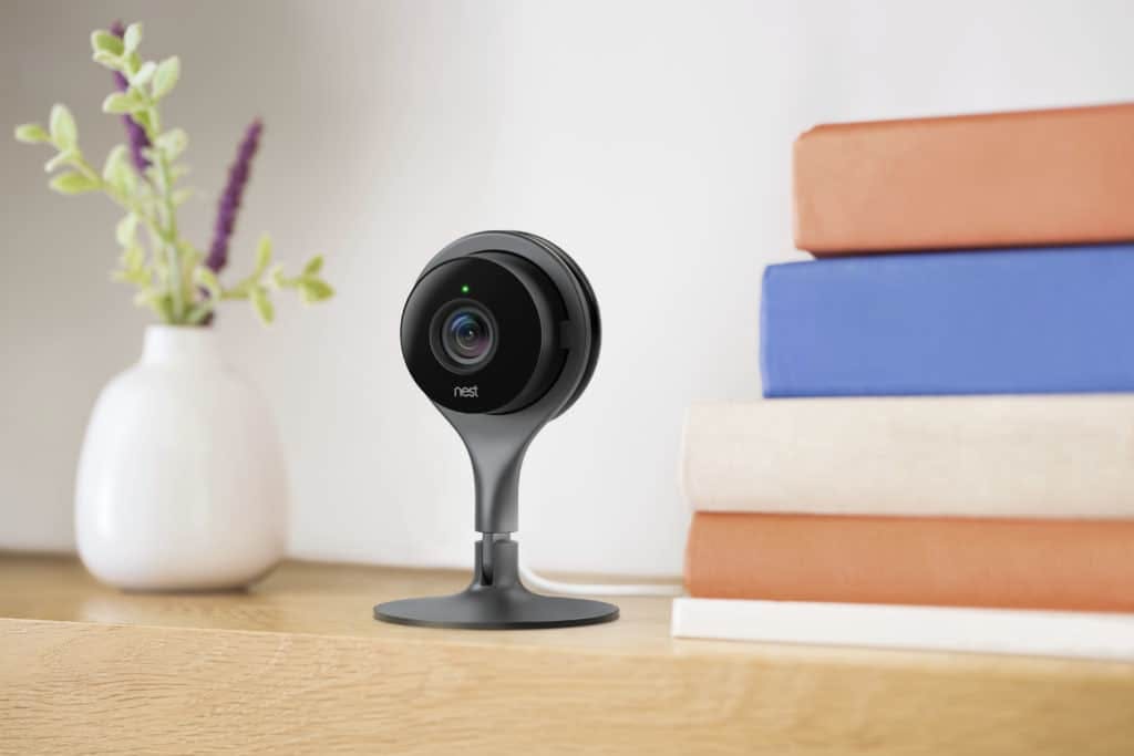 Indoor nest camera on table with books