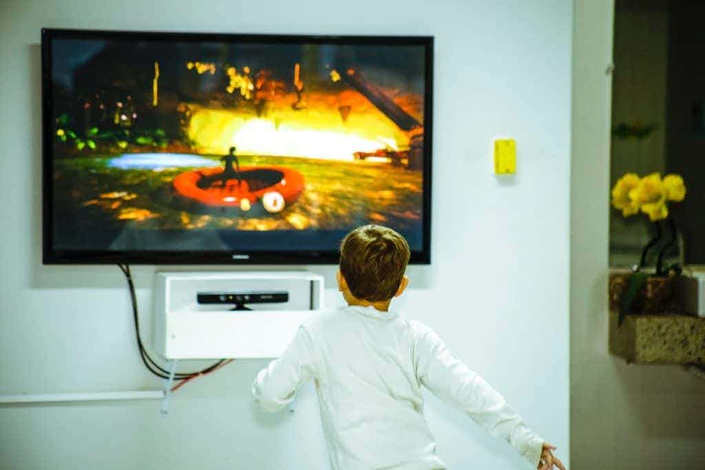 Kid running towards a TV.