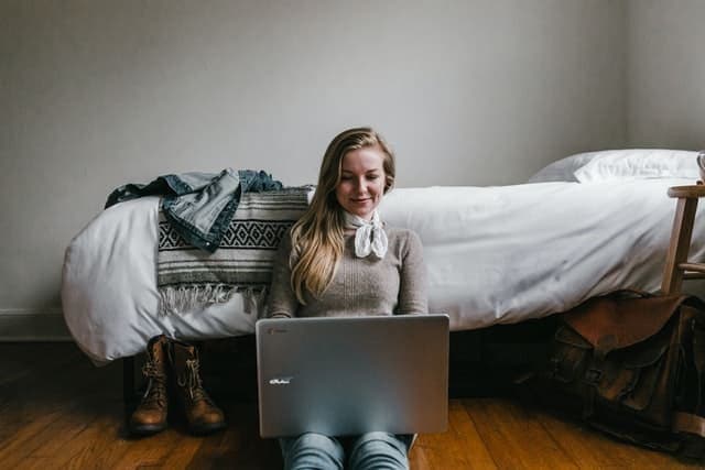Women working on her laptop sitting down