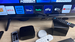 Streaming devices on a table stand and streaming apps showing on screen