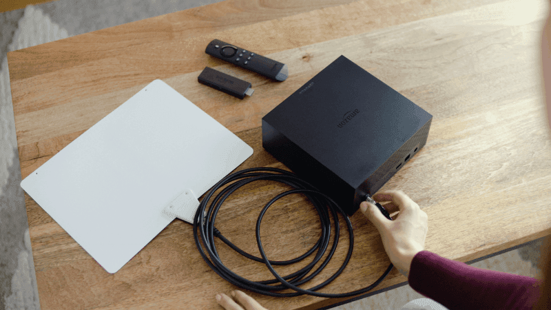 Hand plugging in Fire TV Recast into an antenna.