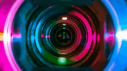 A camera of a webcam with different colors on the lens.
