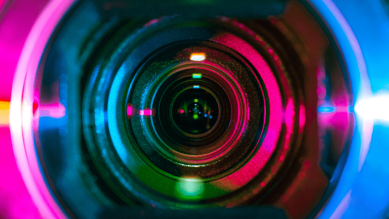 A camera of a webcam with different colors on the lens.