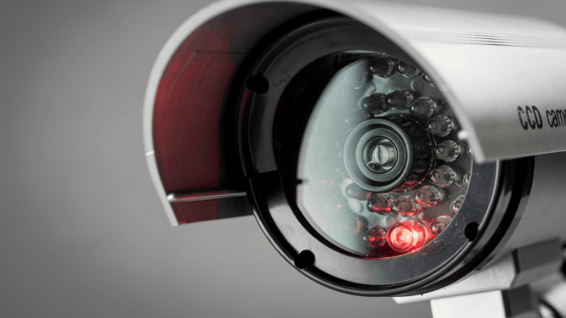 A security camera with a red light on.