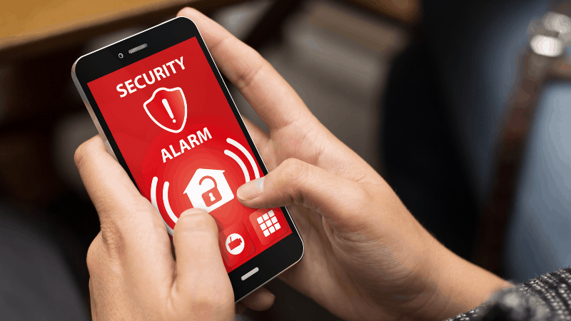 Person on a smartphone on a security alarm app.