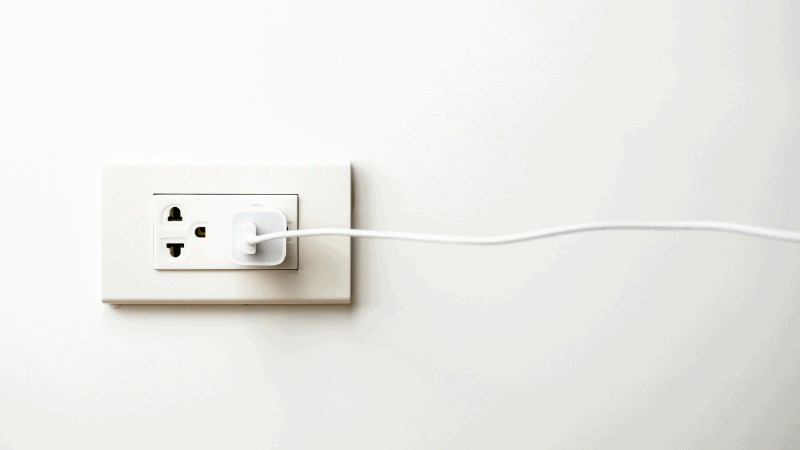 A charging adapter plugged into an outlet