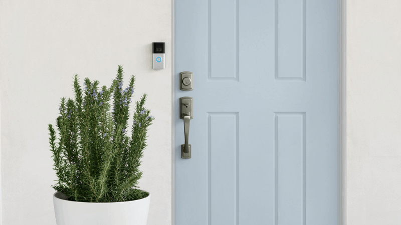 ring doorbell installed outside home with light blue door