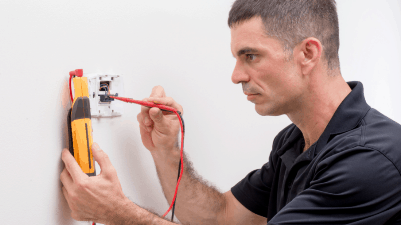 Tech repairing a thermostat