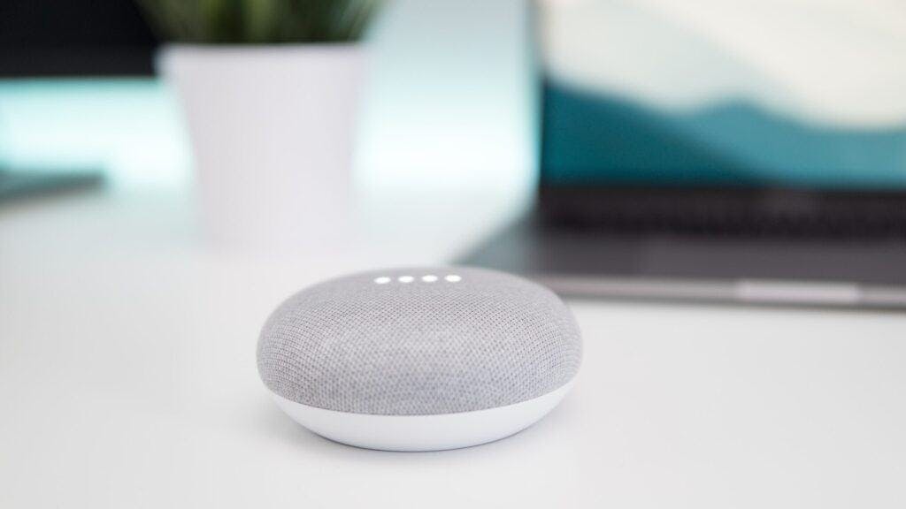 White google nest mini speaker on white counter