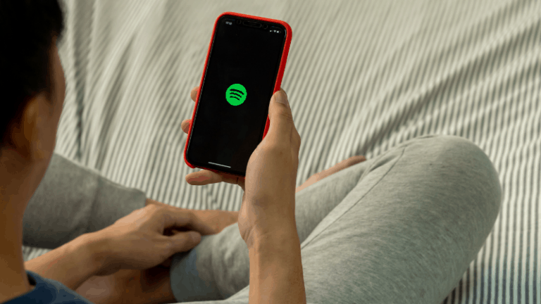 Red iphone with spotify music app