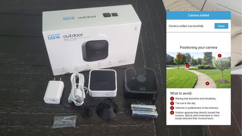 Blink outdoor camera with plugs and box on table