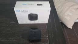 blink outdoor camera with box on black table