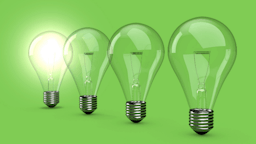lightbulbs on a green background with one bulb lit