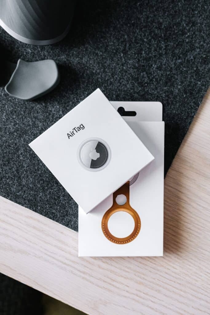 Two boxes of Apple air tag and accessory on table.