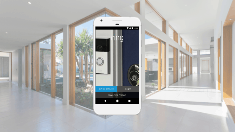 ring app login screen on smartphone with the house hallway in the background.