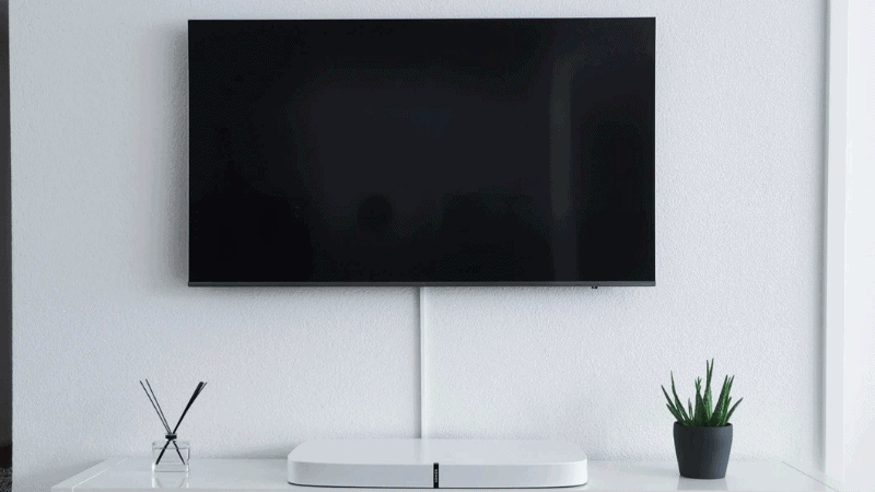 samsung tv mounted to wall in a living room.