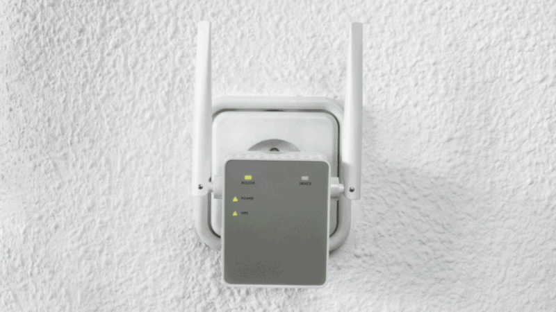 wifi extender installed in home with white walls.