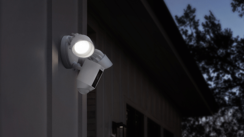 Ring floodlight camera with lights on installed on home.