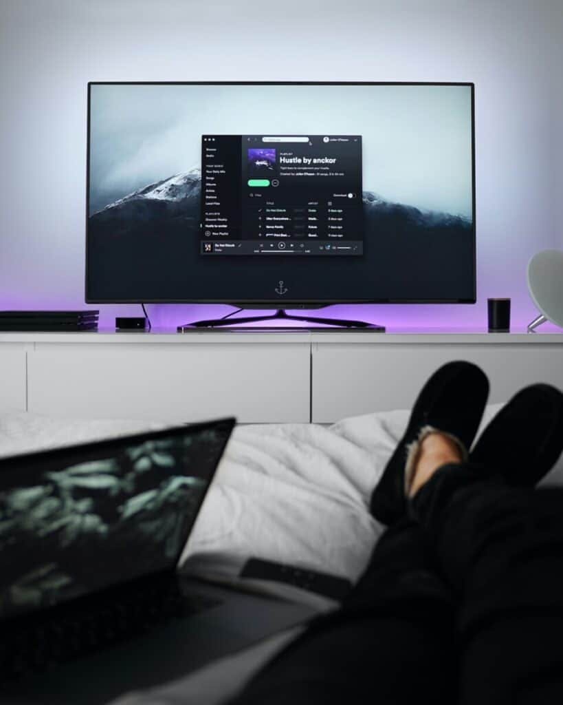 person watching TV with feet up
