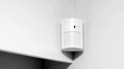 motion sensor mounted to a corner of a wall
