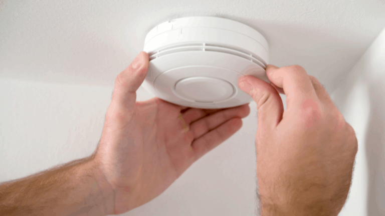 smoke detector being changed by person