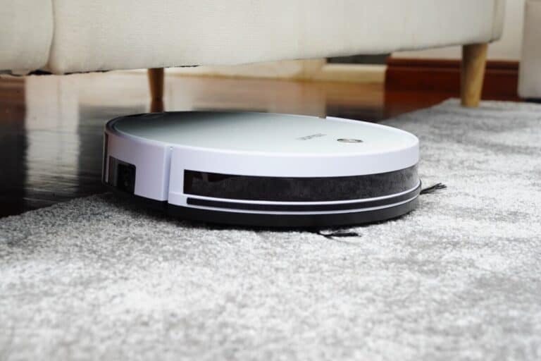 A roomba i7 vacuum on carpet