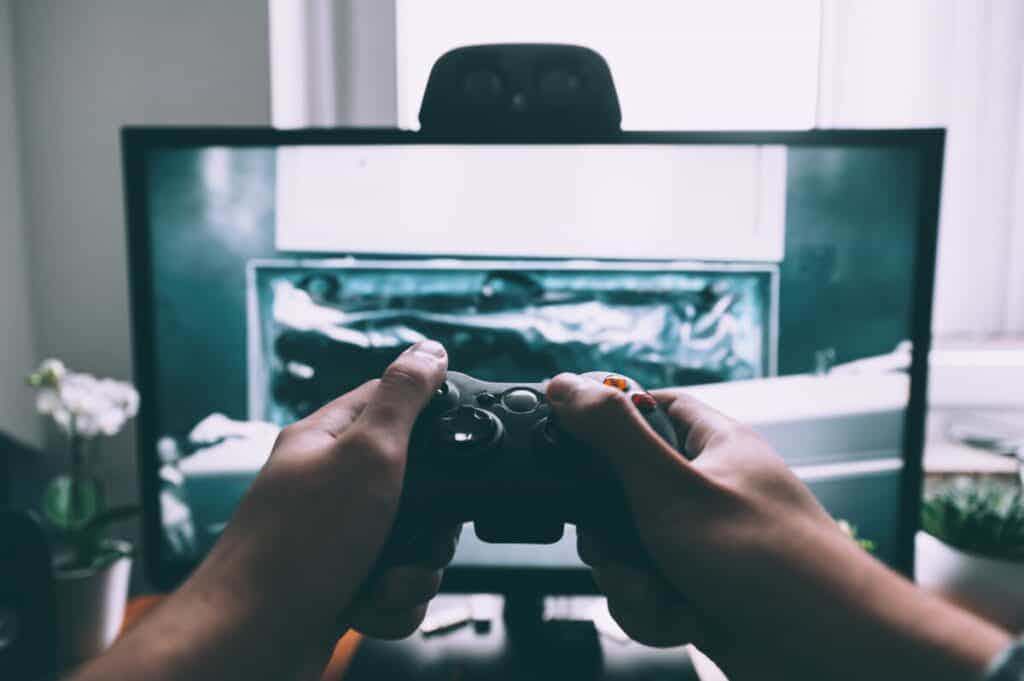 Person playing games with remote in front of TV