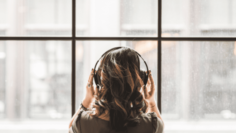 Woman listening to music on her headphones.