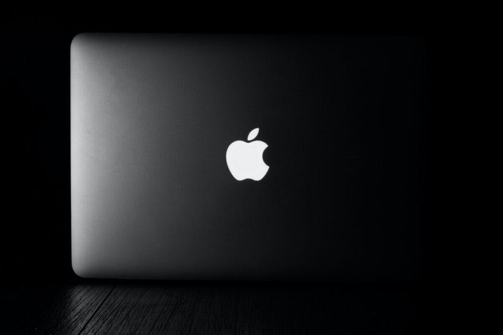 Space grey macbook on black background