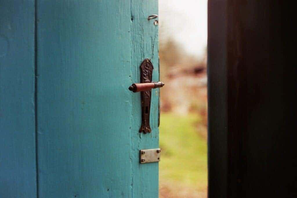an open blue door with deadbolt