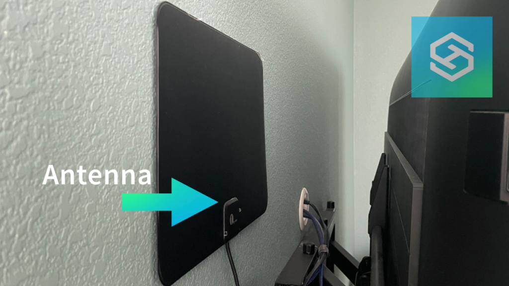 Antenna mounted on wall behind tv