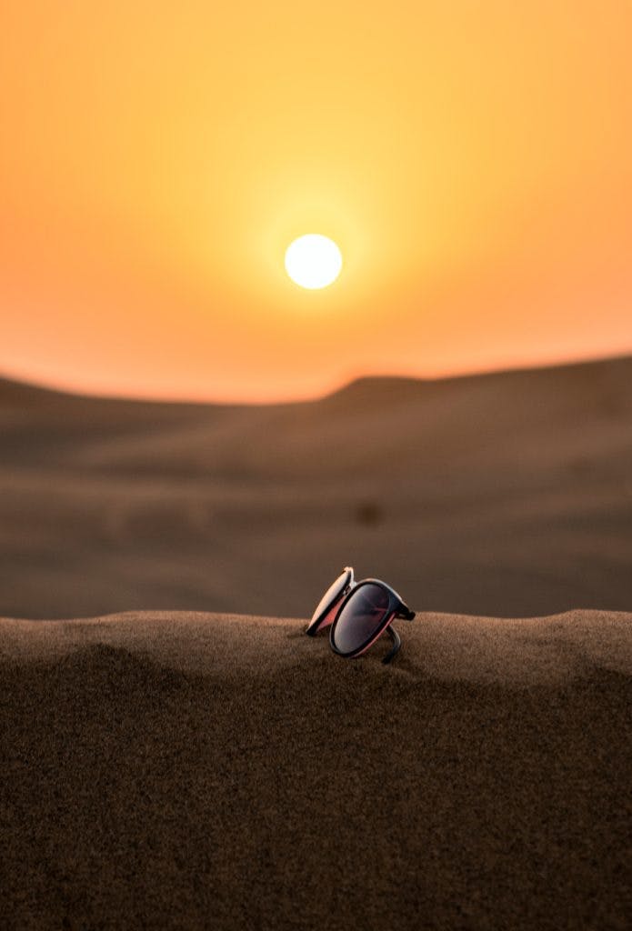 sunglasses under a desert sunset