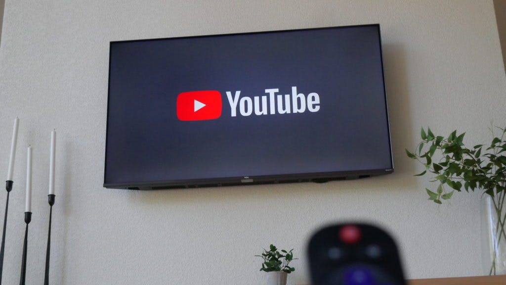 tcl tv on and displaying youtube logo