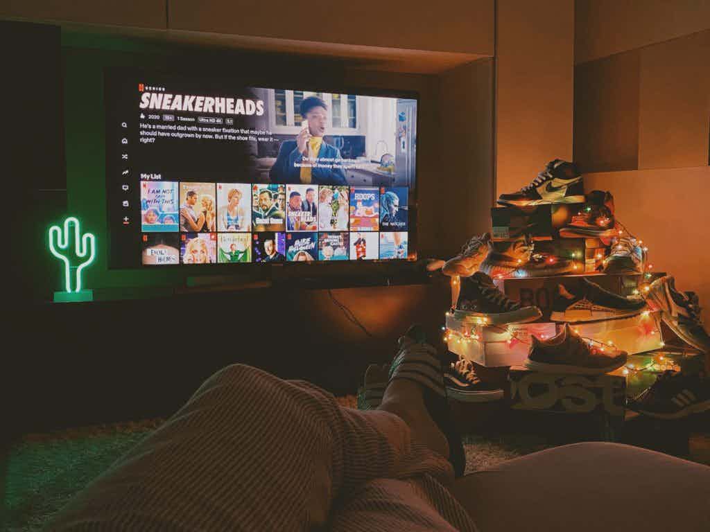 TV with sneaker pile next to it