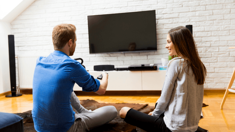 man woman watching smart tv