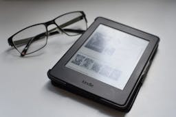Kindle next to glasses