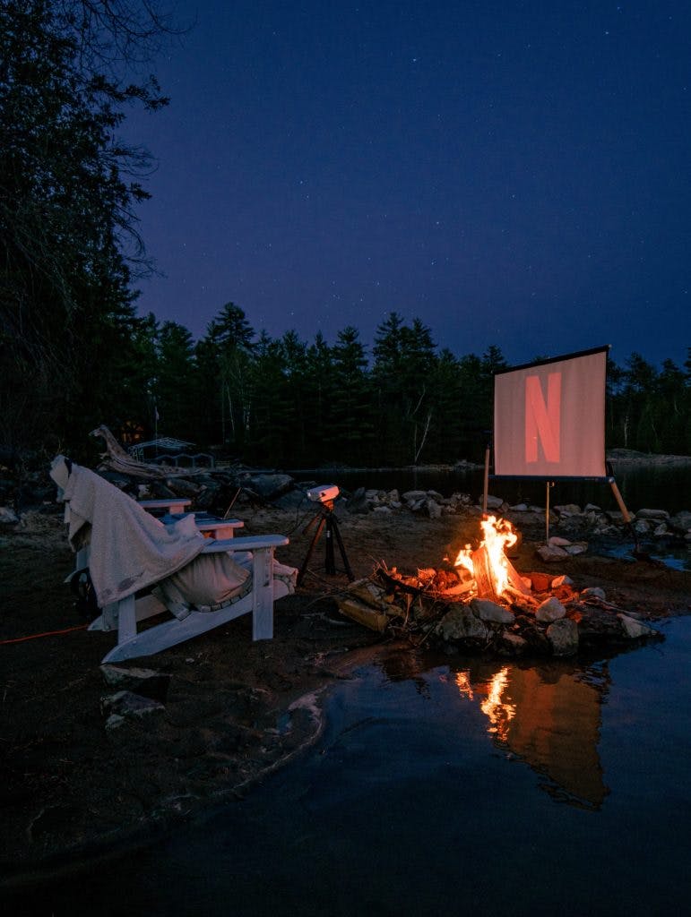 Projecting Netflix by a campfire