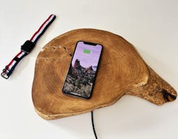 Phone and smartwatch being charged wirelessly