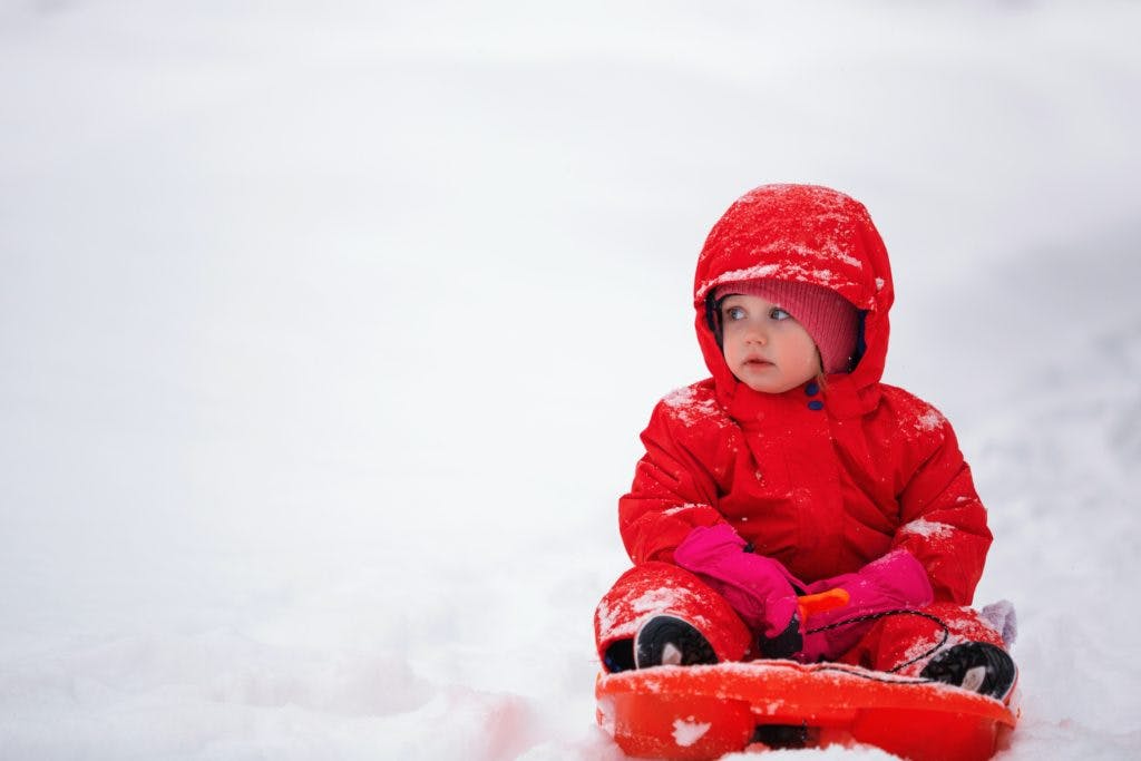 Baby in red in the snow