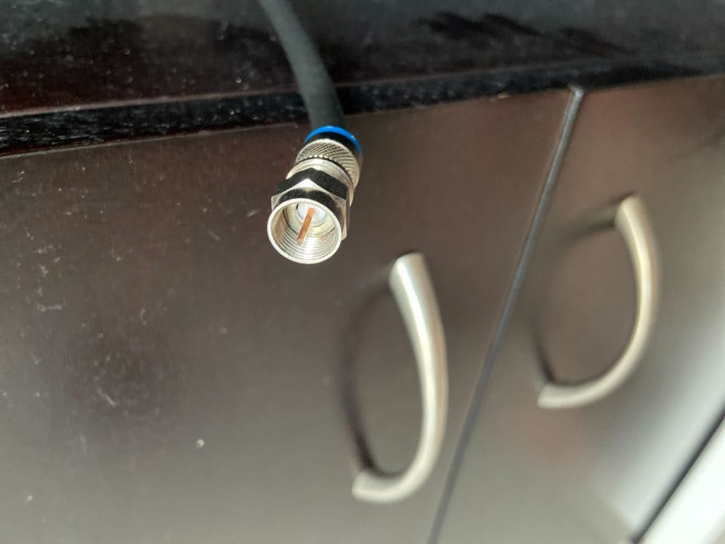 A coaxial cable in a space that recently had a cable box removed.