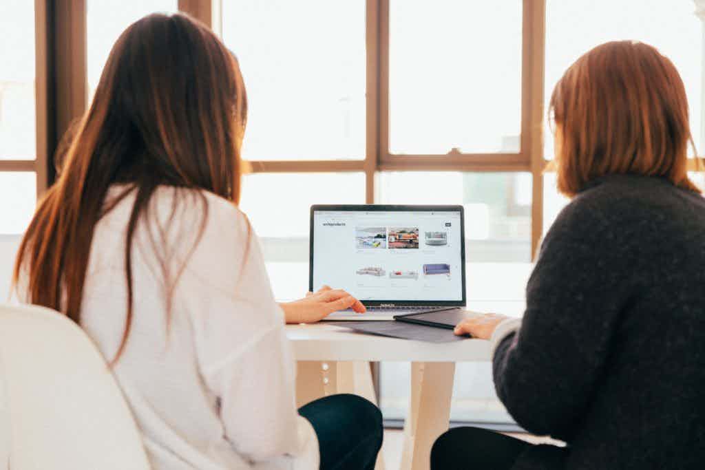 Two women looking at computer