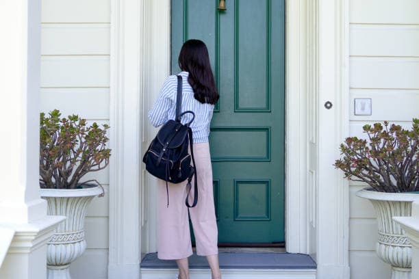 woman opening door