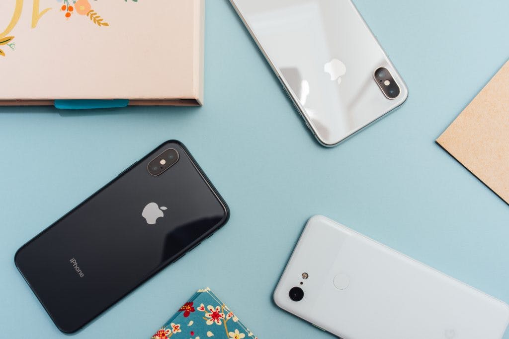 iphones on pale blue background