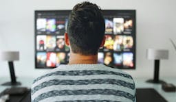 Man in front of TV screen